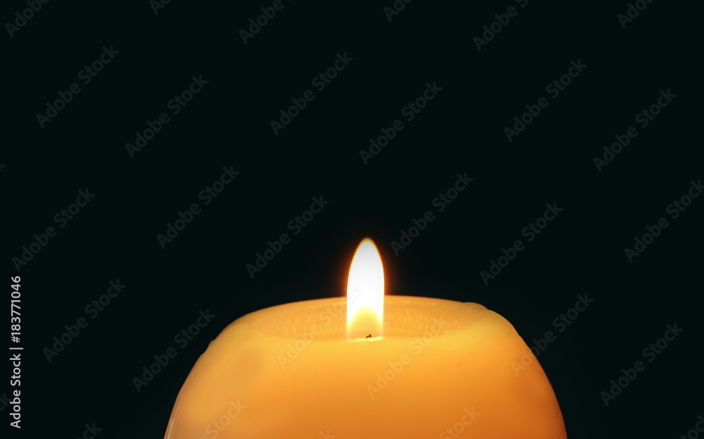 Wax candle burning in darkness, closeup Wax candle burning in darkness, closeup