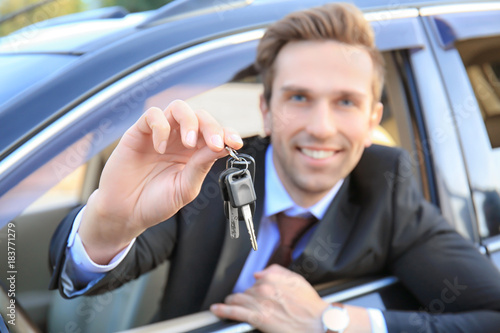Young businessman with keys...