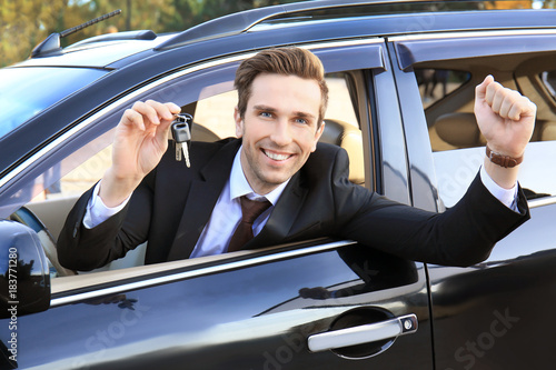Young businessman with keys...