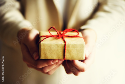 Female hands holding gift box, copy space. Christmas, hew year, birthday, valentines day concept.