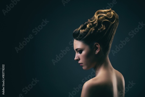Portrait of a young woman wearing a bun, profile photo
