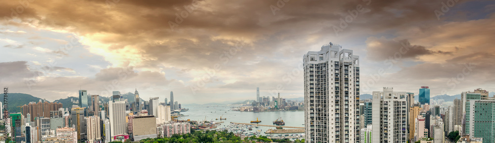 HONG KONG - MAY 12, 2014: Stunning panoramic view of Hong Kong Island and Kowloon on a cloudy day. Last year HK hosted more than 54 million visitors, most of them from the mainland