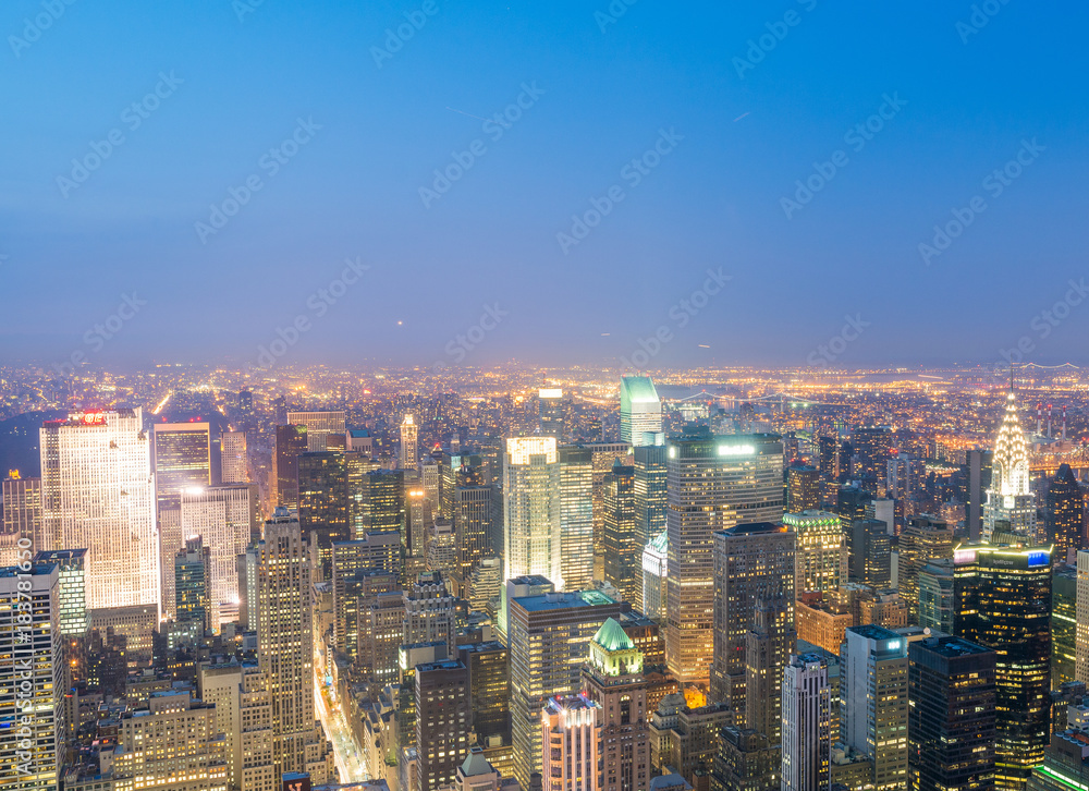 NEW YORK CITY - JUNE 9, 2013: Aerial night view of Midtown Manhattan. New York attracts 50 million tourists every year