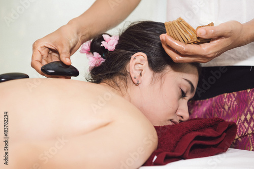 Thai Spa therapy on the girl lay on bed with many item around, spa and massage concept