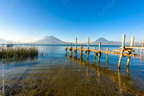 Fotografie, Obraz Wooden pier at Lake Atitlan on the shore at Panajachel, Guatemala