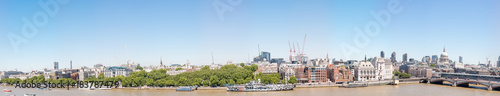 LONDON - MAY 2013: Beautiful panoramic view of city buildings along river Thames. London attracts 30 million tourists annually