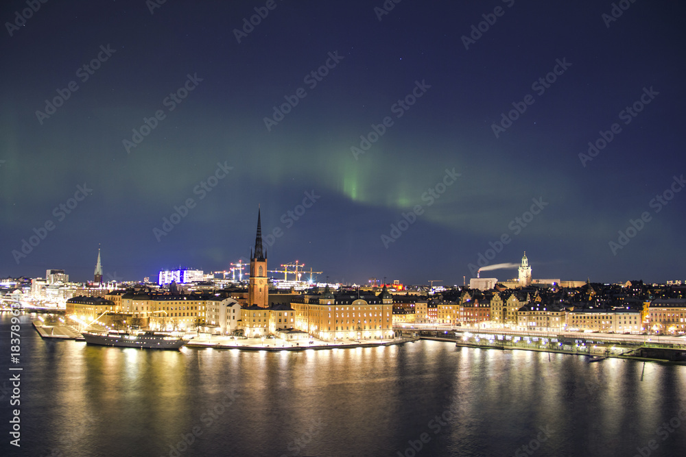 Scenic night panorama of the Stockholm with visible northern lights, Sweden