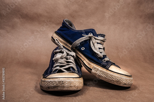 old dirty sneakers on a kraft background