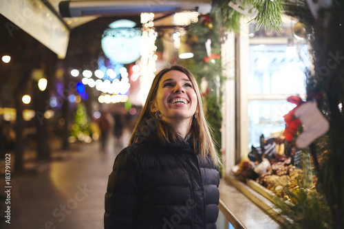 Woman at Christmas market looking up smiling, Odessa, Odessa Oblast, Ukraine, Europe photo