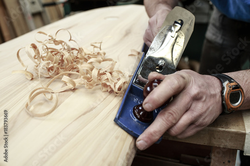 Carpenter planing surfboard