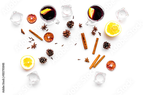 Ingredients for mulled wine. Spices cinnamon and badian, citrus fruits on white background top view copyspace
