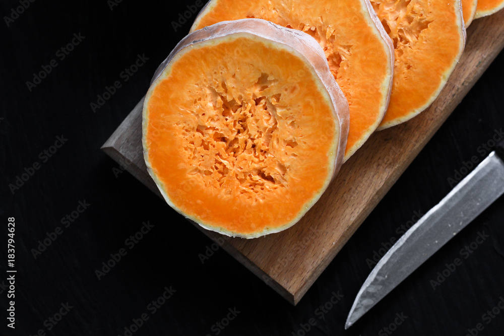 fresh pumpkin chopped on a round piece fresh pumpkin chopped on a round piece