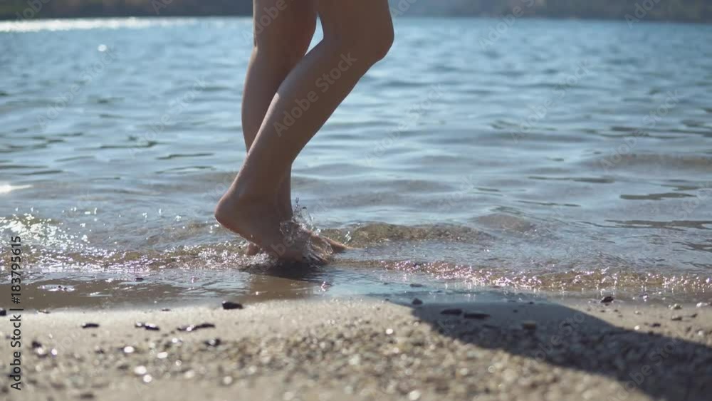 beautiful female Feet Walking Barefoot on Sea Shore. beautiful female Feet Walking Barefoot on Sea Shore.