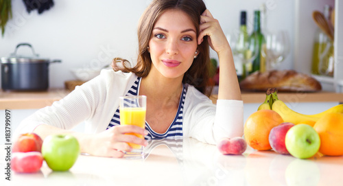 Portrait of a pretty woman holding glass with tasty juice