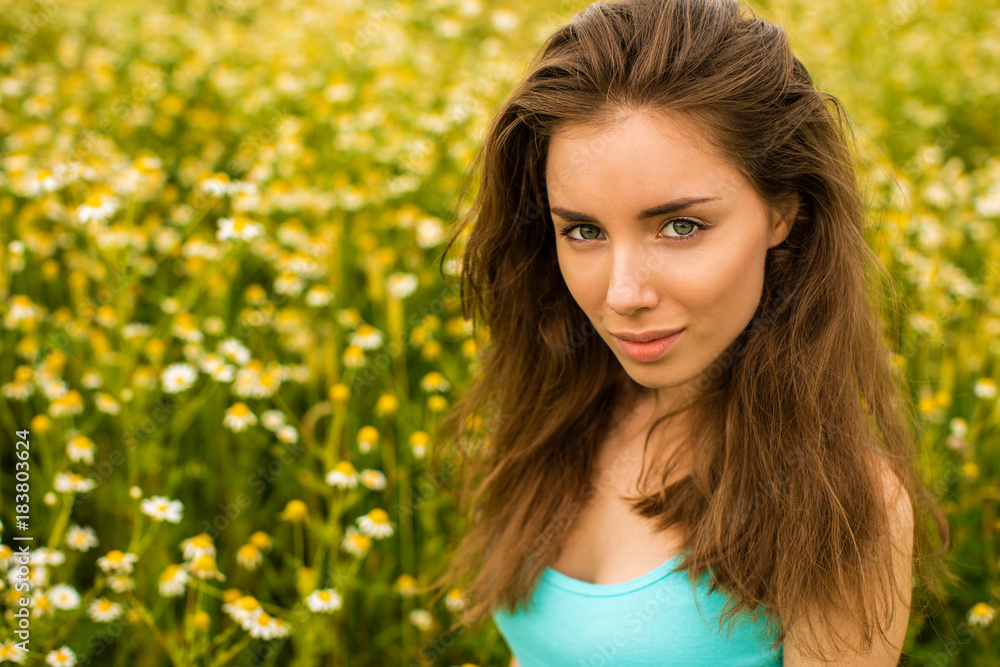 Photo of pretty brunette woman in chamomile field Photo of pretty brunette woman in chamomile field