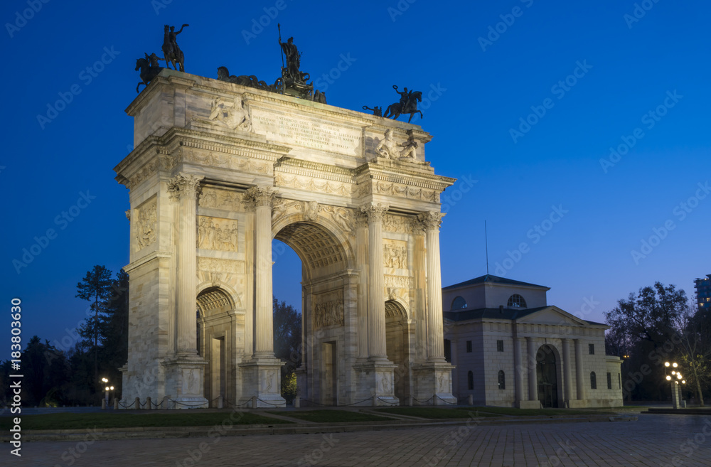 Arch of Peace (Arco della Pace) in Sempione Park with Sforza castle in the background, Milan, Italy. Night view.