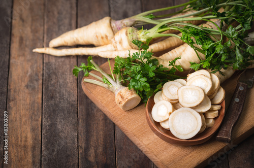 Fresh parsley root on the wooden table photo
