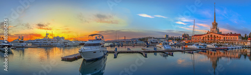 SOCHI, RUSSIA - APRIL 26, 2015: Panorama with sunset - boats and yachts on the quay in the seaport photo
