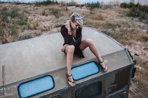 Woman sitting on top of truck looking down, Odessa, Odeska Oblast, Ukraine, Europe photo