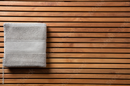 Concept for shower or spa with towel over wooden board