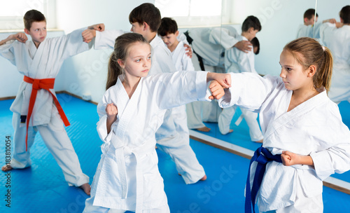 Smiling children sparring in pairs