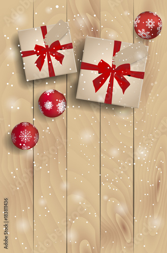 top view on christmas presents with red christmas balls on plank wooden table
