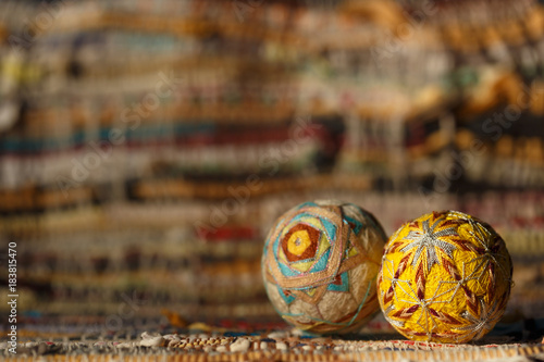 Temari balls, two traditional Japanese temari hand balls on a motley background