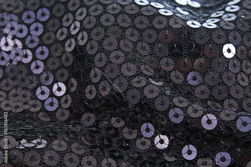 Black sequins, sequin pailette background. Mirror dress material cloth texture pattern. Tailoring stitching concept. Shiny mirrored fashion fabric. Shiny clothing material sample. Creased fabric.