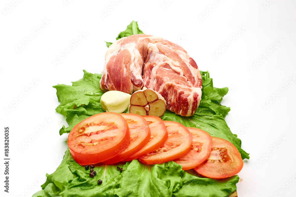 a piece of pork and tomatoes a piece of pork and tomatoes
