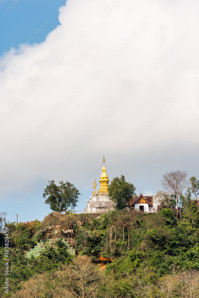 View of the Buddhist temple on the mountain, Louangphabang, Laos. Copy space for text. Vertical.