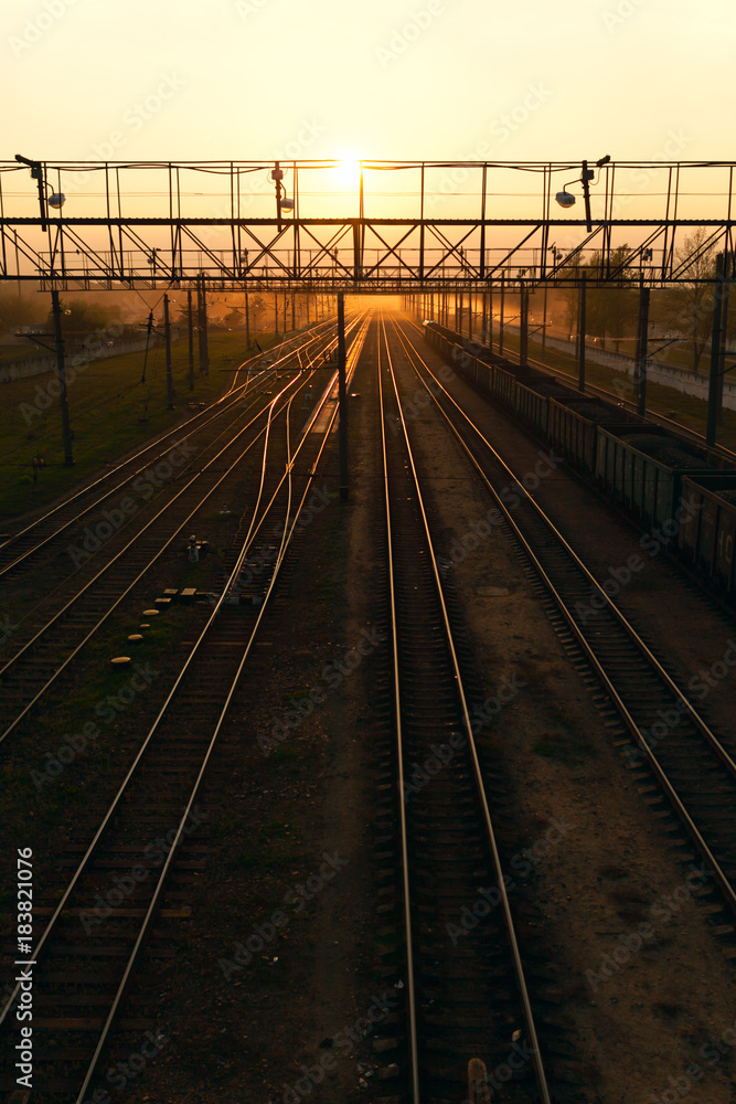 Beautiful sunset on the background of railway tracks