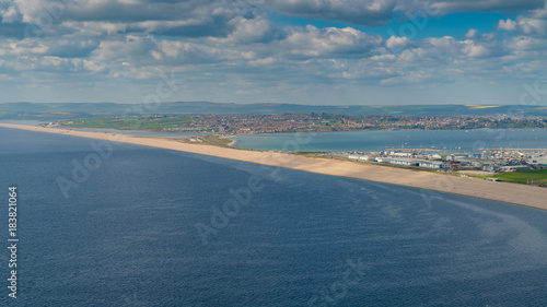View from the South West Coast Path towards Fortuneswell and Chesil Beach, Isle of Portland, Jurassic Coast, Dorset, UK - with clouds over Weymouth in the background