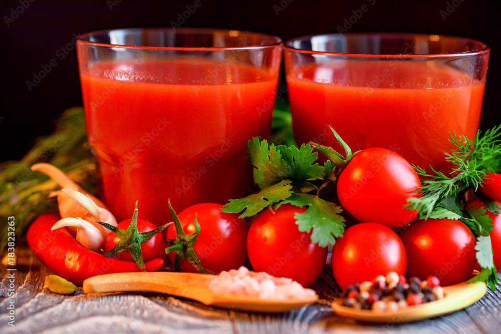 Glass of tomato juice with fresh tomatoes Glass of tomato juice with fresh tomatoes