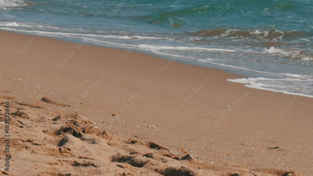 Beach in Spain. Waves of the Mediterranean Sea hit the sand on the beach in Spain Beach in Spain. Waves of the Mediterranean Sea hit the sand on the beach in Spain