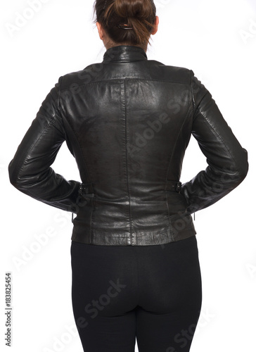 Young woman wearing leather motorcycle jacket isolated on white background