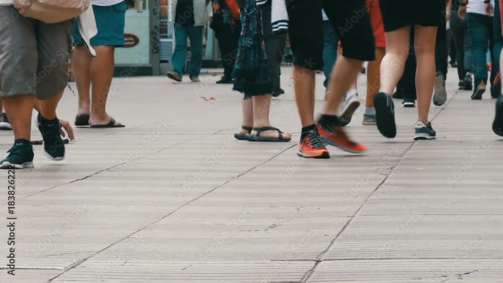 People pedestrians walk cross big city. Footsteps of a crowd of people go on business in the metropolis People pedestrians walk cross big city. Footsteps of a crowd of people go on business in the metropolis
