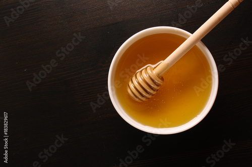 Honey on a wooden background © sergeylapin
