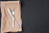 The knife and fork is located on the towel and a place for recording.