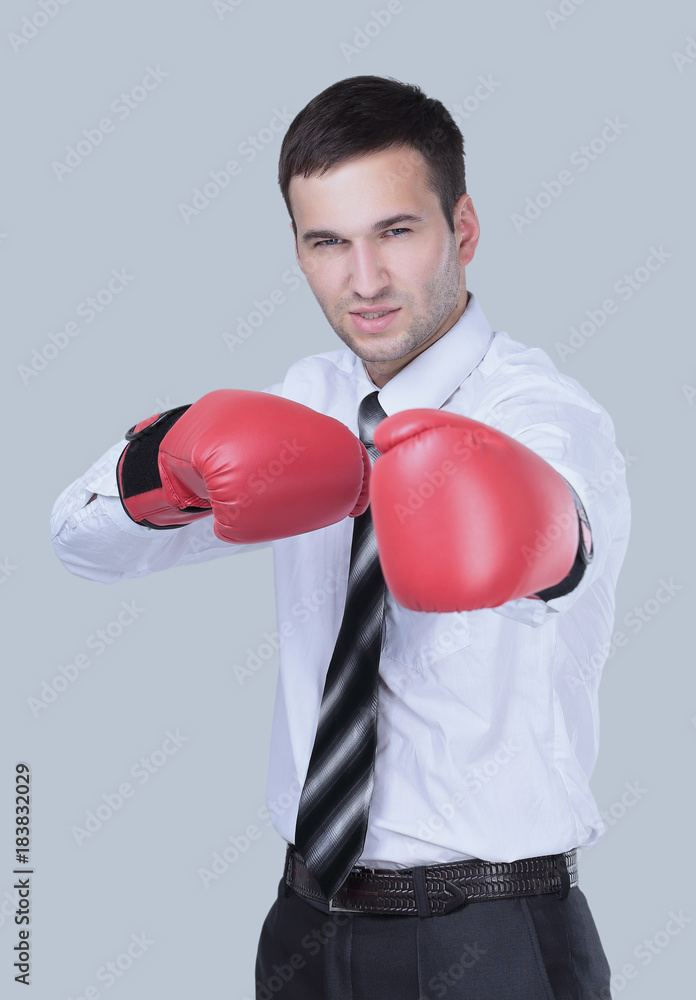 Business man with boxing gloves is ready for corporate battle.
