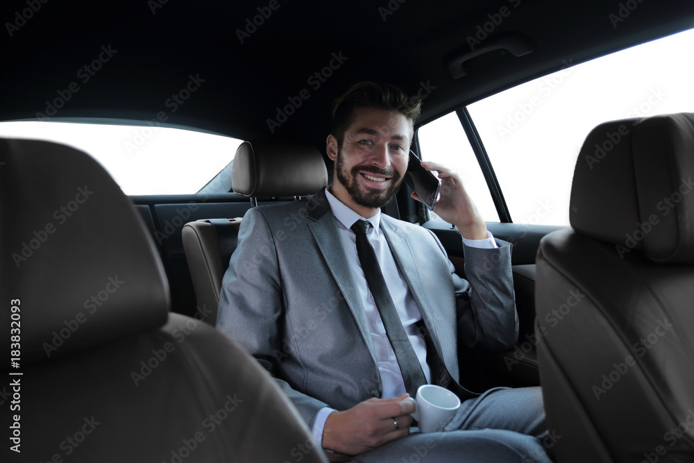 businessman sitting in car with cup and smartphone businessman sitting in car with cup and smartphone