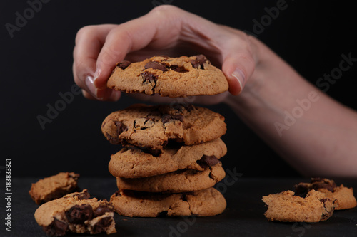 Woman arranging Christmas chocolate chip cookies close up. Baking at home concept