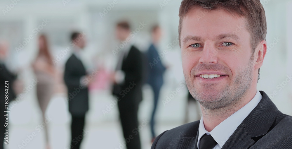 Happy mature business man looking at camera with satisfaction at office Happy mature business man looking at camera with satisfaction at office
