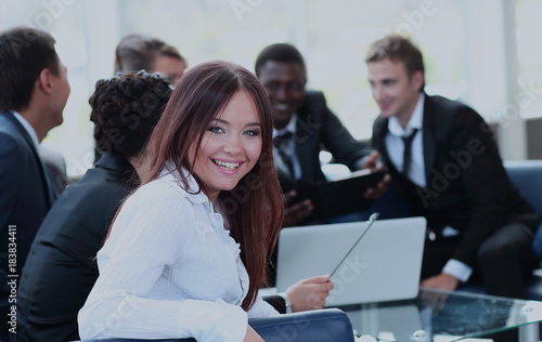 Beautiful young woman looking at camera with smile at the modern