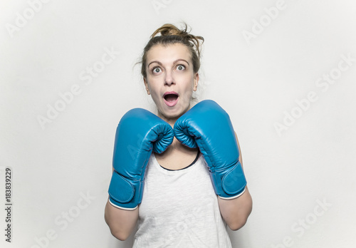 Young woman boxer wearing gloves. © Oleksandr