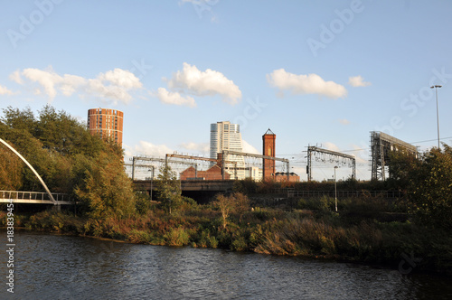 the river aire in leeds taken from the footpath showing the south bank and holbeck with the railway tracks in between