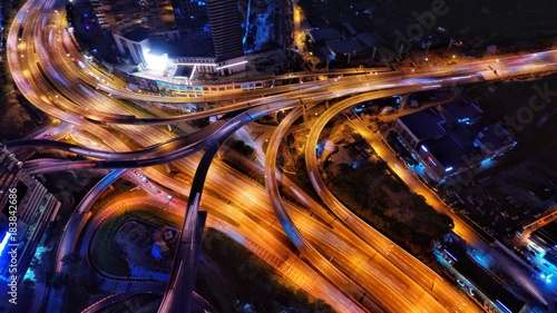 Aerial photography of urban city highway with traffic's light trail at night.