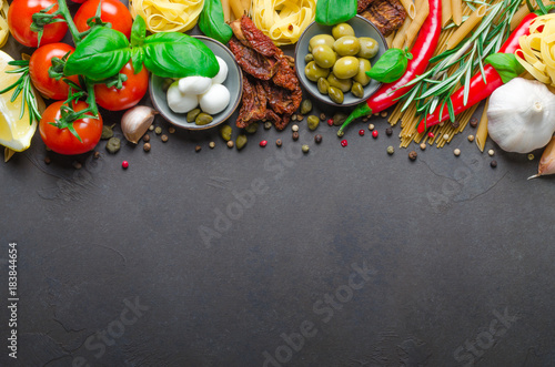 Italian food on a dark background with copy space, ingredients f