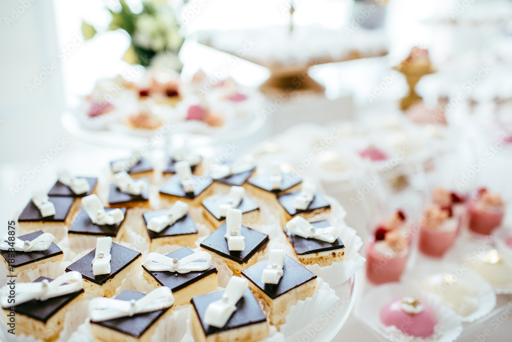 Table with loads of cakes, cupcakes, cookies and cakepops.