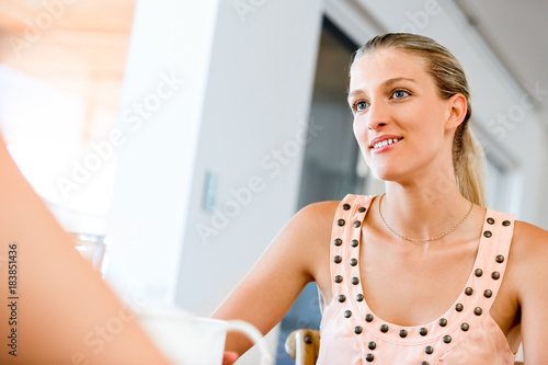 Free Download Young woman with her friend sitting at the table - GFXLoad