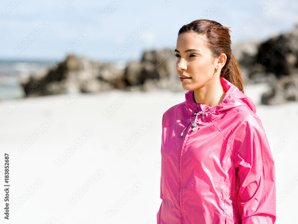 Athletic woman in sportswear standing at the seaside Athletic woman in sportswear standing at the seaside